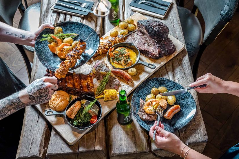 Fleisch, Gemüse und Fisch und andere frische Speisen auf dem Restauranttisch im Salzburger Land